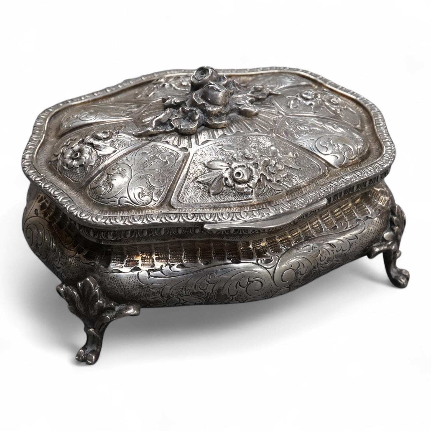 An ornate early 20th century Italian 800 standard white metal trinket casket, of shaped oval form, with embossed and engraved decoration, on four cabriole feet, 12.2cm, 9.2oz.